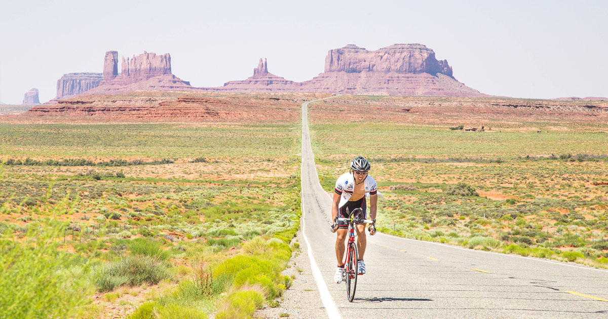 Justin Too bicycling through Monument Valley